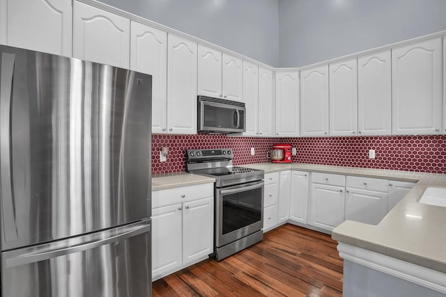 4887 Rays Cir, Dublin, OH 43016 - kitchen with appliances with stainless steel finishes, white cabinets, backsplash, light countertops, and dark wood-style flooring