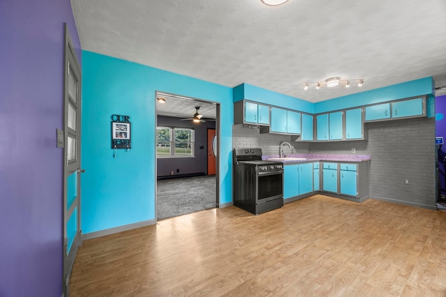 94 Fox Chase Dr, Newark, OH 43055 - kitchen with stove, a textured ceiling, light wood-style floors, and ceiling fan