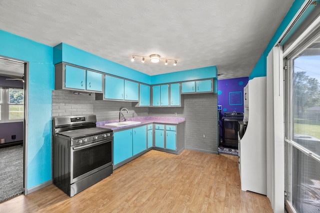 94 Fox Chase Dr, Newark, OH 43055 - kitchen featuring stainless steel electric stove, range, freestanding refrigerator, and light wood-type flooring