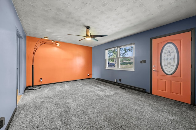 94 Fox Chase Dr, Newark, OH 43055 - carpeted foyer entrance with a ceiling fan, a textured ceiling, and a baseboard heating unit