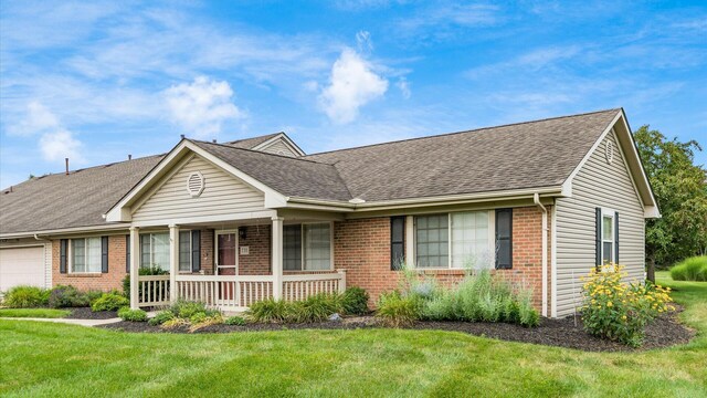 733 Windsor Ln, Heath, OH 43056 - single story home with brick siding, covered porch, a front yard, and a shingled roof