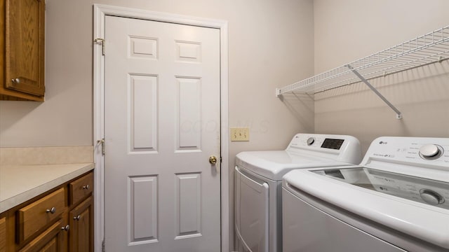 733 Windsor Ln, Heath, OH 43056 - laundry area with washing machine and clothes dryer and cabinet space