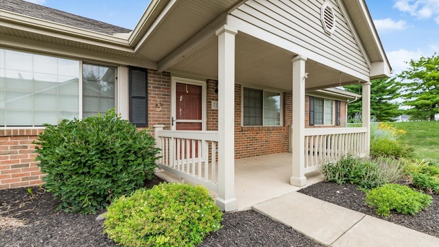 733 Windsor Ln, Heath, OH 43056 - property entrance with brick siding, covered porch, and roof with shingles