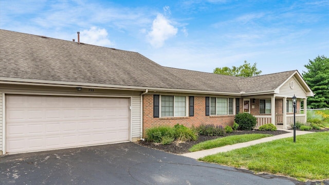 733 Windsor Ln, Heath, OH 43056 - view of front of house featuring a shingled roof, driveway, brick siding, a porch, and a garage