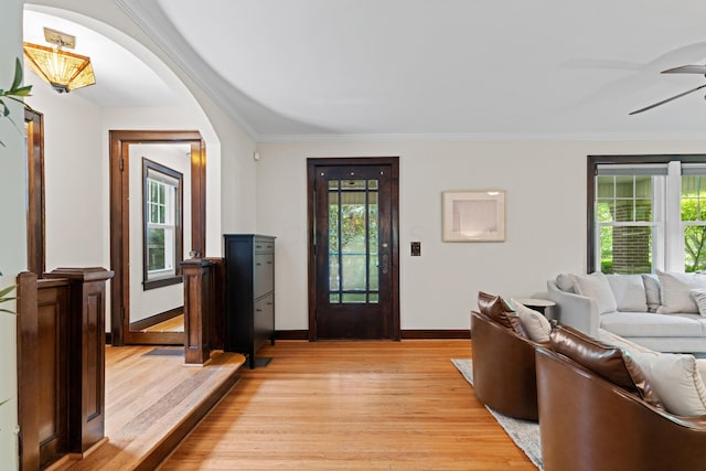 99 E N Broadway St, Columbus, OH 43214 - foyer featuring light wood finished floors, healthy amount of natural light, arched walkways, and ornamental molding