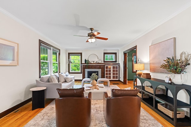 99 E N Broadway St, Columbus, OH 43214 - living area featuring ornamental molding, light wood-style flooring, a ceiling fan, and a fireplace