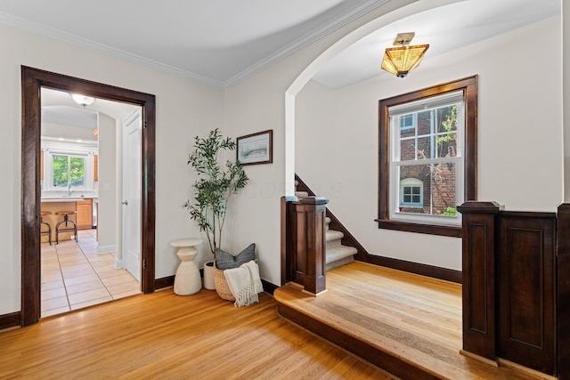 99 E N Broadway St, Columbus, OH 43214 - entryway with light wood finished floors, arched walkways, stairs, and crown molding