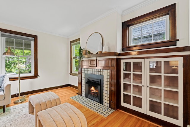 99 E N Broadway St, Columbus, OH 43214 - living room featuring light wood-style floors, a fireplace, and crown molding