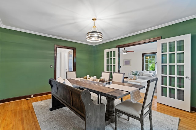 99 E N Broadway St, Columbus, OH 43214 - dining area with ornamental molding, light wood-type flooring, and a chandelier