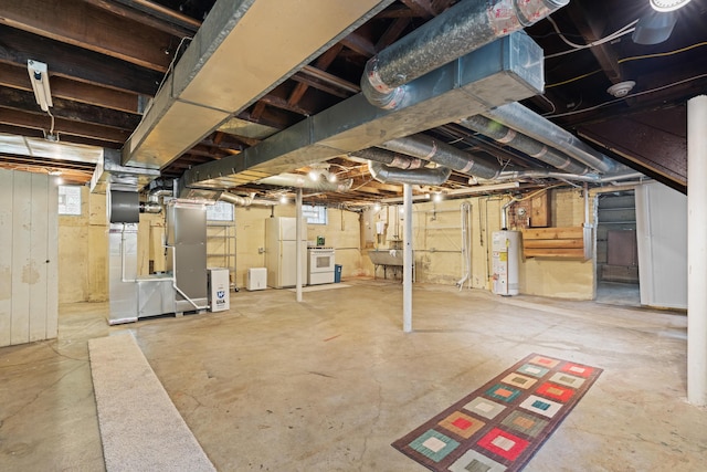 99 E N Broadway St, Columbus, OH 43214 - basement featuring gas water heater, freestanding refrigerator, and heating unit