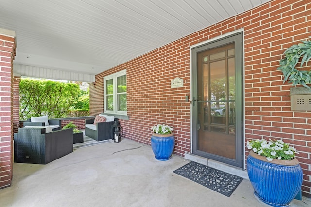 99 E N Broadway St, Columbus, OH 43214 - view of exterior entry featuring brick siding, outdoor lounge area, and covered porch