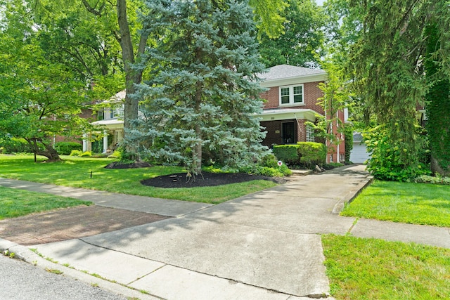 99 E N Broadway St, Columbus, OH 43214 - view of front of home with brick siding, a front lawn, and concrete driveway