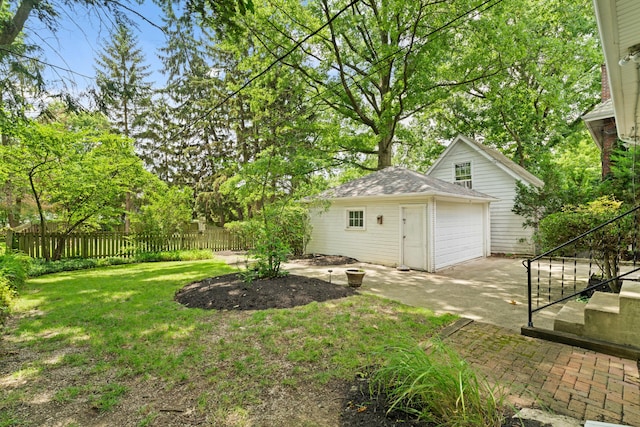 99 E N Broadway St, Columbus, OH 43214 - view of yard featuring an outdoor structure, a patio, and concrete driveway