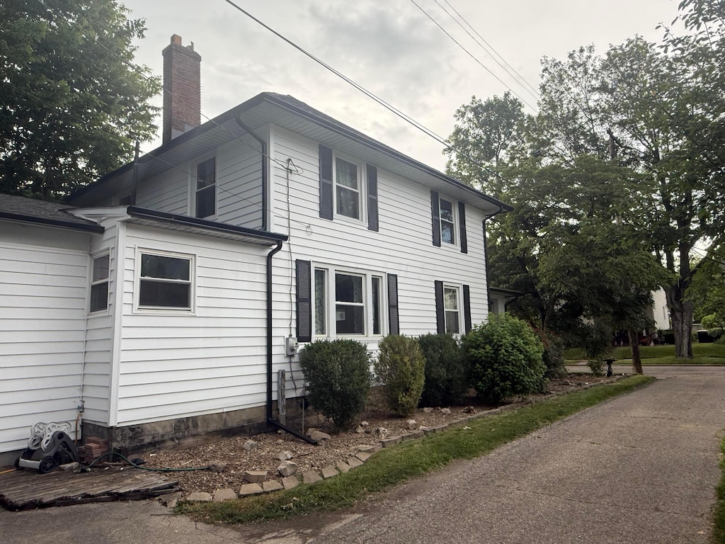 147 W Shields St, Newark, OH 43055 - view of home's exterior with a chimney