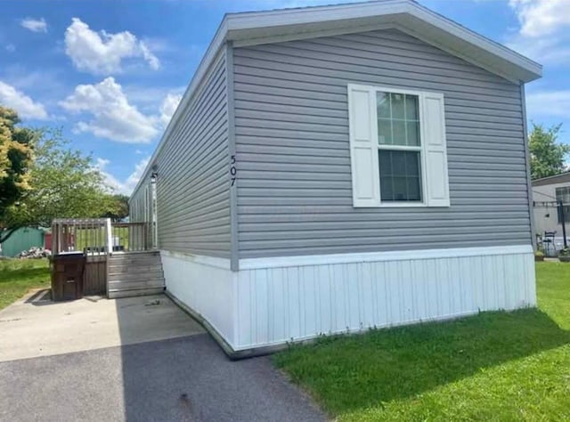 1330 Hanover Rd Unit 507, Delaware, OH 43015 - view of side of property featuring a yard, a deck, and a patio