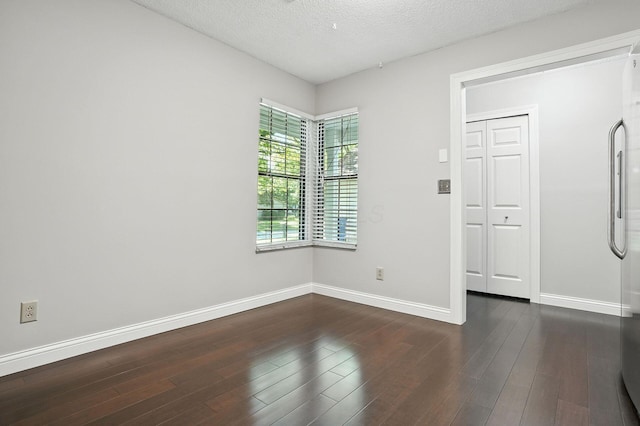 5975 Meadowsglen Dr, Dublin, OH 43017 - unfurnished room featuring dark wood finished floors and a textured ceiling