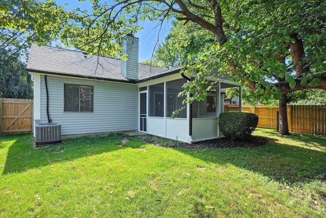 5975 Meadowsglen Dr, Dublin, OH 43017 - rear view of property with a sunroom, a chimney, a fenced backyard, and roof with shingles