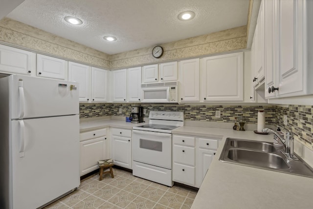 892 Shelbourne Pl, Newark, OH 43055 - kitchen with white appliances, a textured ceiling, white cabinetry, light countertops, and decorative backsplash