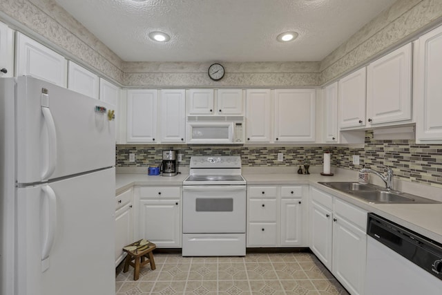 892 Shelbourne Pl, Newark, OH 43055 - kitchen with white appliances, a textured ceiling, white cabinets, and light countertops