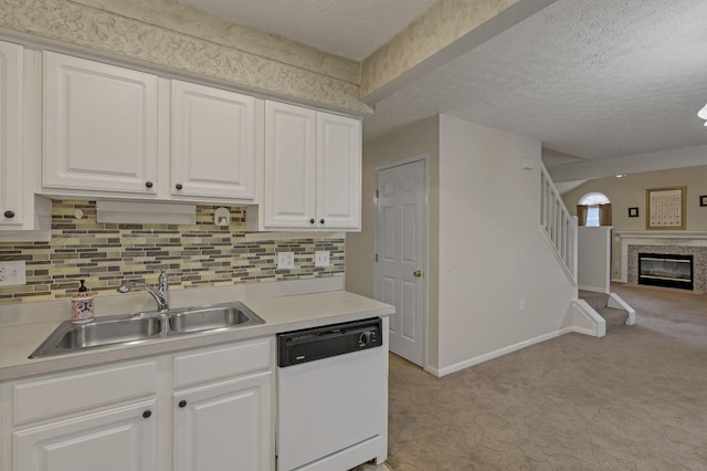 892 Shelbourne Pl, Newark, OH 43055 - kitchen featuring white dishwasher, light carpet, open floor plan, light countertops, and a textured ceiling