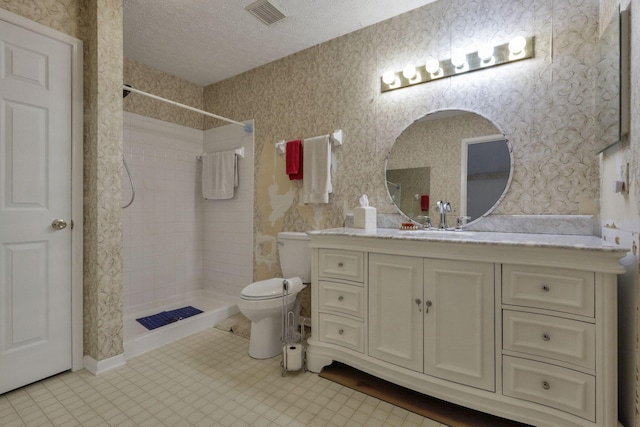 892 Shelbourne Pl, Newark, OH 43055 - full bathroom featuring vanity, a textured ceiling, tiled shower, and wallpapered walls