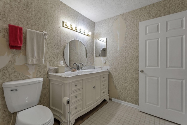 892 Shelbourne Pl, Newark, OH 43055 - bathroom featuring a textured ceiling, vanity, tile patterned floors, and wallpapered walls