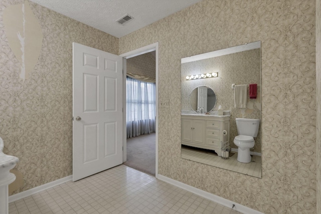 892 Shelbourne Pl, Newark, OH 43055 - bathroom featuring vanity, a textured ceiling, and wallpapered walls