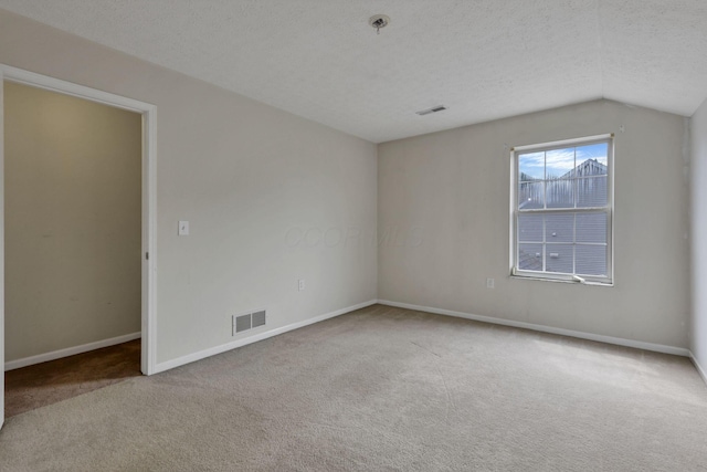 892 Shelbourne Pl, Newark, OH 43055 - carpeted empty room featuring lofted ceiling and a textured ceiling