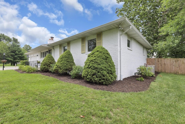 54 Barry Rd SW, Reynoldsburg, OH 43068 - view of side of property with a chimney and an attached garage
