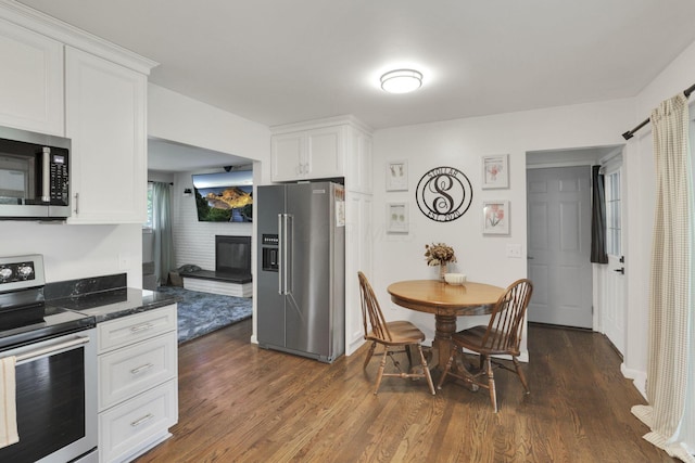 54 Barry Rd SW, Reynoldsburg, OH 43068 - kitchen featuring appliances with stainless steel finishes, dark wood-style floors, and white cabinets