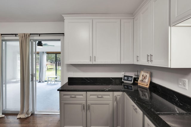 54 Barry Rd SW, Reynoldsburg, OH 43068 - kitchen with white cabinetry, dark wood-type flooring, dark stone countertops, and a ceiling fan
