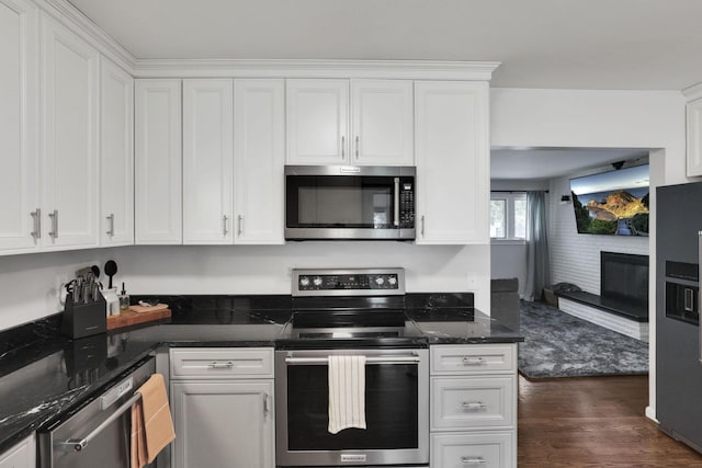 54 Barry Rd SW, Reynoldsburg, OH 43068 - kitchen featuring appliances with stainless steel finishes, white cabinets, dark wood-type flooring, and dark stone countertops