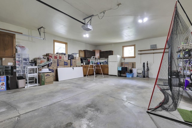54 Barry Rd SW, Reynoldsburg, OH 43068 - garage with freestanding refrigerator and a garage door opener