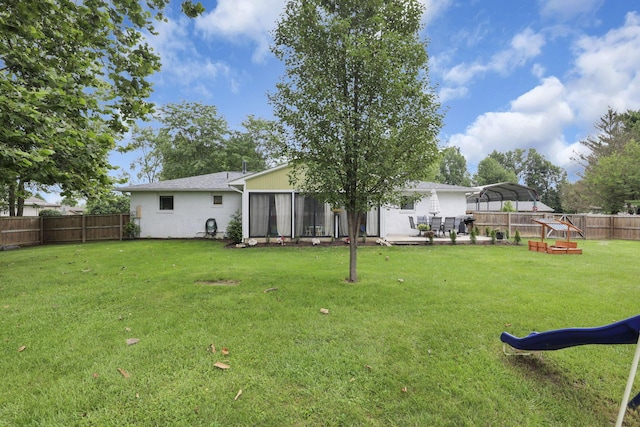54 Barry Rd SW, Reynoldsburg, OH 43068 - fenced backyard with a detached carport, a playground, and a sunroom