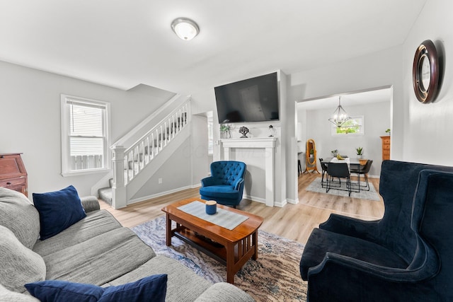 1008 E Whittier St, Columbus, OH 43206 - living area featuring stairway, plenty of natural light, wood finished floors, and a chandelier