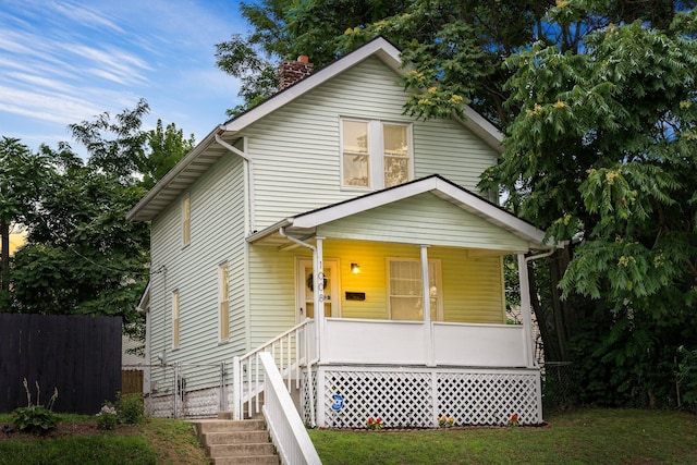 1008 E Whittier St, Columbus, OH 43206 - view of front of house with covered porch and a chimney