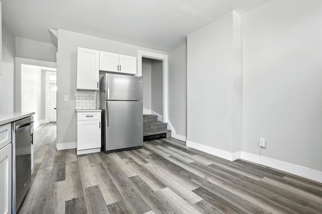 538 W Town St, Columbus, OH 43215 - kitchen with appliances with stainless steel finishes, white cabinets, wood finished floors, and light countertops