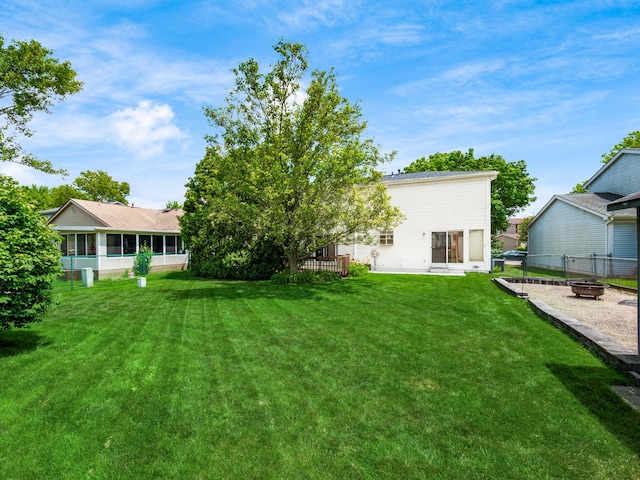 2883 Castlebrook Ave, Hilliard, OH 43026 - view of yard with an outdoor fire pit and a sunroom