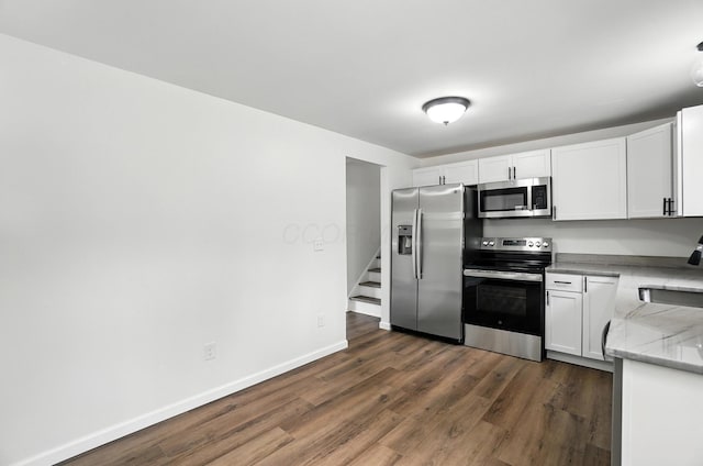 5244 Refugee Rd, Columbus, OH 43232 - kitchen featuring stainless steel appliances, dark wood-style flooring, white cabinetry, and light stone countertops