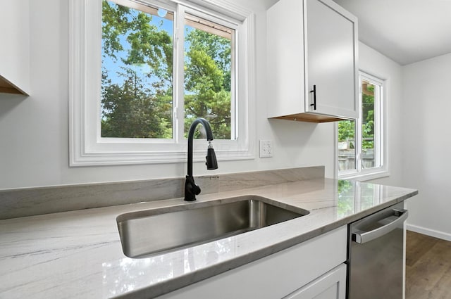 5244 Refugee Rd, Columbus, OH 43232 - kitchen with dishwasher, white cabinets, light stone counters, and wood finished floors