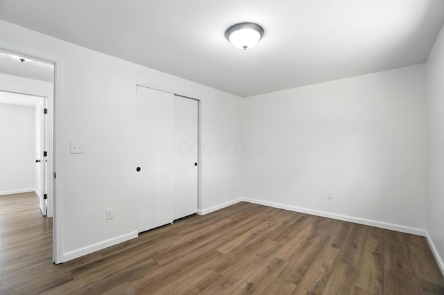 5244 Refugee Rd, Columbus, OH 43232 - unfurnished bedroom with wood finished floors and a closet