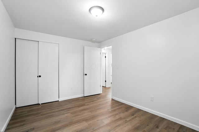 5244 Refugee Rd, Columbus, OH 43232 - unfurnished bedroom with wood finished floors and a closet