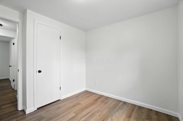 5244 Refugee Rd, Columbus, OH 43232 - unfurnished bedroom with wood finished floors and a closet