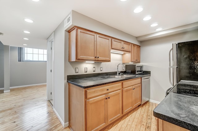 444 N Front St Unit 312, Columbus, OH 43215 - kitchen with appliances with stainless steel finishes, light wood-style flooring, recessed lighting, and dark countertops