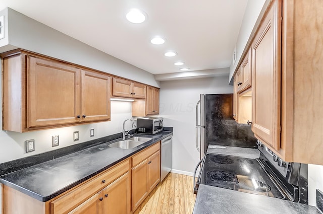 444 N Front St Unit 312, Columbus, OH 43215 - kitchen featuring stainless steel appliances, light wood-style floors, recessed lighting, and dark countertops