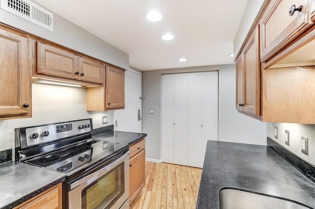444 N Front St Unit 312, Columbus, OH 43215 - kitchen with stainless steel electric stove, dark countertops, recessed lighting, and light wood-style floors