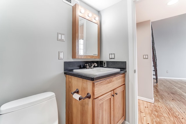 444 N Front St Unit 312, Columbus, OH 43215 - half bathroom featuring vanity and wood finished floors