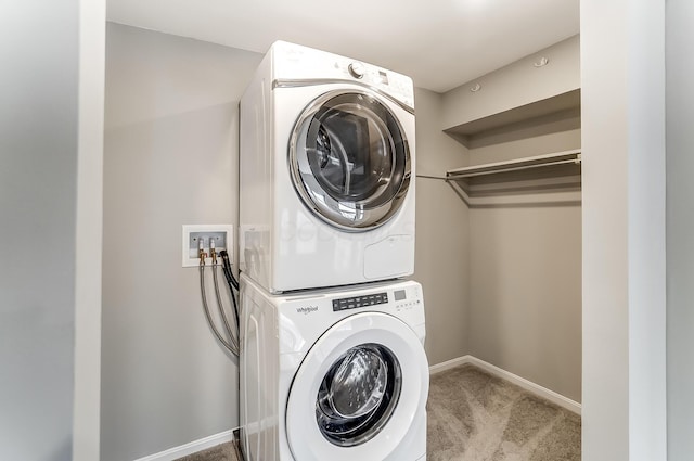 444 N Front St Unit 312, Columbus, OH 43215 - laundry area with stacked washing machine and dryer and carpet floors