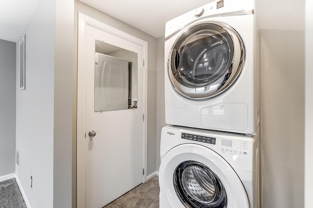 444 N Front St Unit 312, Columbus, OH 43215 - washroom featuring stacked washing machine and dryer and carpet flooring