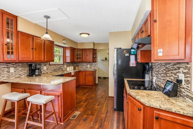 3251 Old Mill Rd NE, Lancaster, OH 43130 - kitchen with ventilation hood, a peninsula, tasteful backsplash, brown cabinets, and dark wood-style flooring